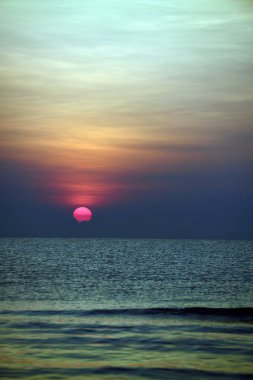 Deniz kenarında parlak gün batımı, renkli doğa..