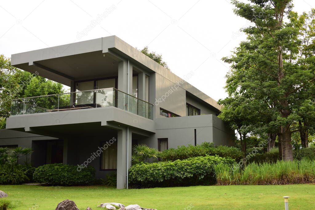 modern house with green grass and trees