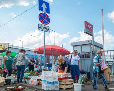 Kyiv, Ukraine 17th August,2025, Street market in Kyiv city showing local women selling fresh vegetables, fruit, and flowers under colorful umbrellas. Urban everyday life and community atmosphere