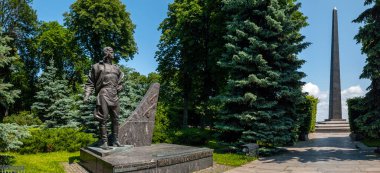 Kyiv, Ukraine 3d June,2025, Historic monument and obelisk at Park of Eternal Glory in Kyiv, Ukraine, commemorating fallen soldiers, set among lush greenery, pathways, and bright blue sky