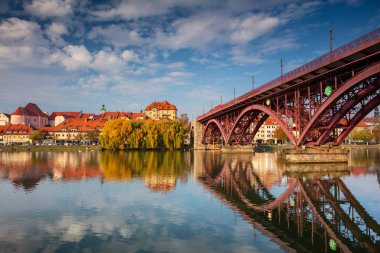 Maribor, Slovenia. Cityscape image of Maribor, Slovenia during autumn day with reflection of the city in Drava River. clipart