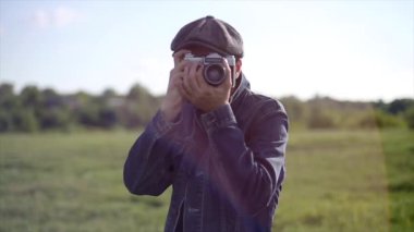 Hipster fotoğrafçı kamera önünde Vintage fotoğraf makinesi ile fotoğraf çekmek 