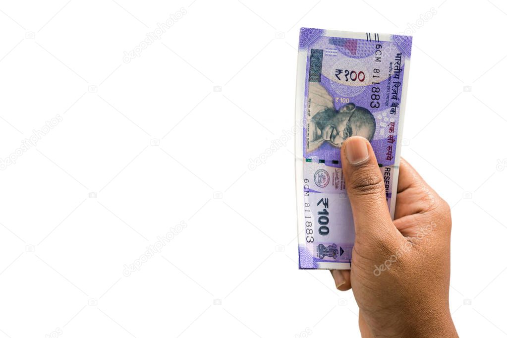 Hand holding Indian New 100 rupee notes on isolated background