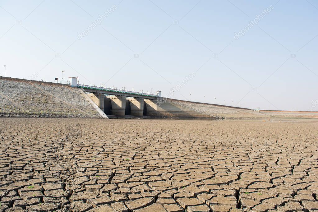 A dried up empty reservoir or dam during a summer heatwave, low rainfall and drought in north karnataka,India