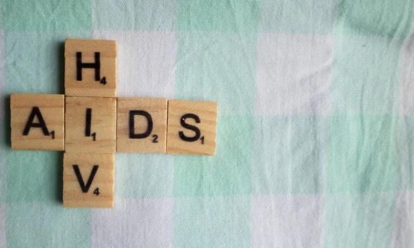 AIDS HIV in wooden block letters on bed