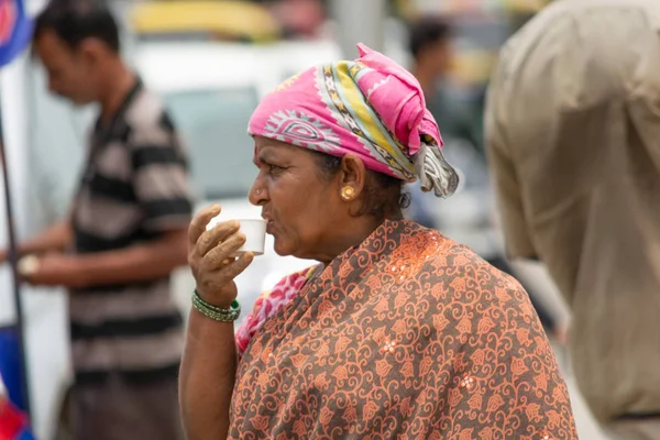 Bangalore, Karnataka India-juni 04 2019: Indiase vrouw het drinken van thee op straat na het voltooien van het werk. — Stockfoto