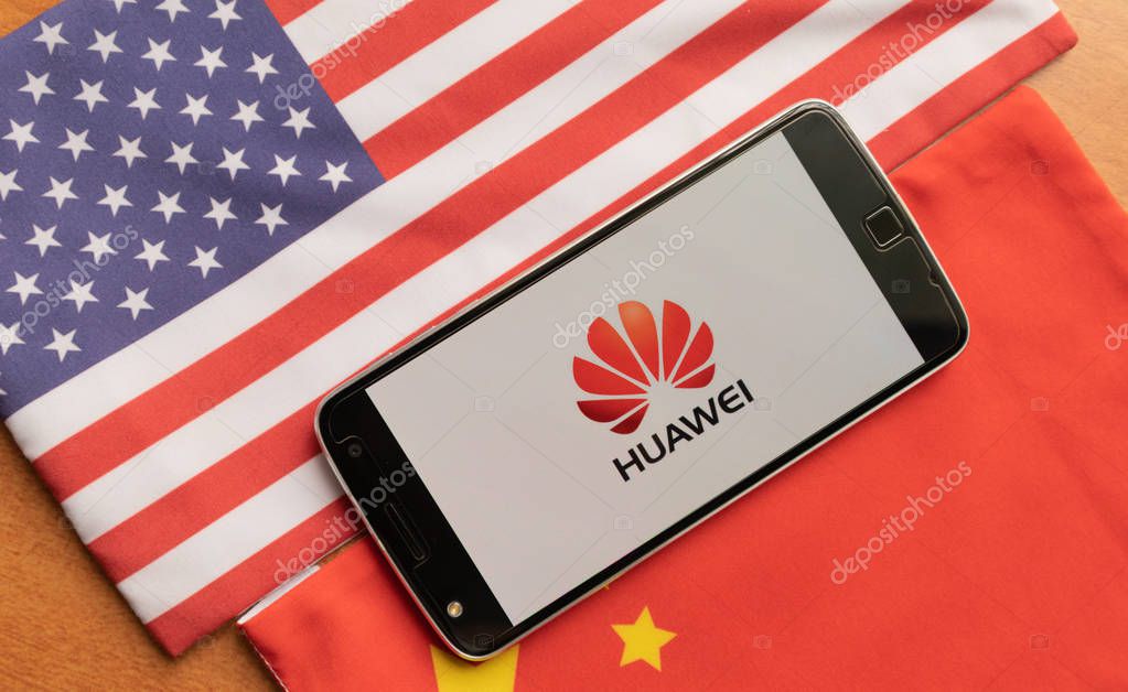 Bangalore, India, June 4, 2019 : Huawei Logo in Mobile, kept on the US and china flag