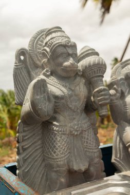 Beautifully carved statue of Hindu god Hanuman or Maruti rock sculpture at hampi for selling. clipart