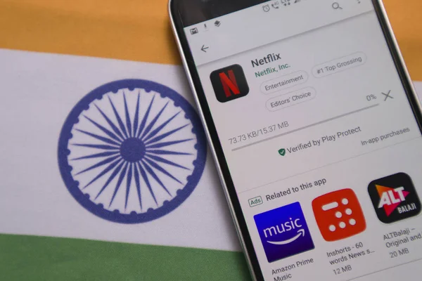 Maski, India - July 30, 2019: Netflix app downloading on Mobile with Indiain Flag as background. — Stock Photo, Image