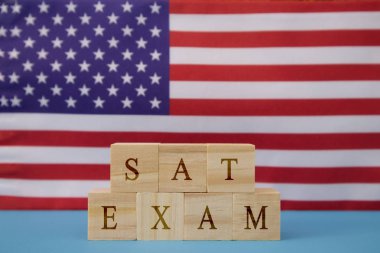 SAT Exam in WOoden blook letters on US flag clipart