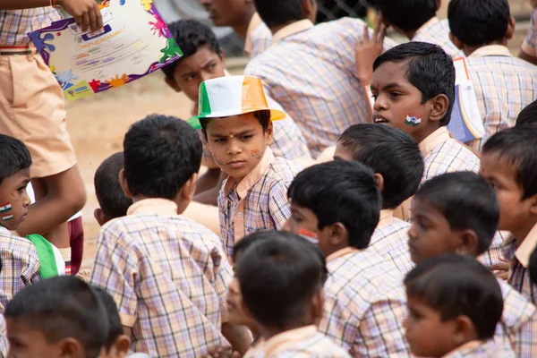 Група початкової школи діти сиділи на землі в день незалежності Індії — стокове фото