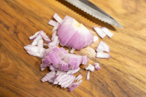 Close up Chopped red onion on the kitchen cutting board with Knife. — Stock Photo, Image