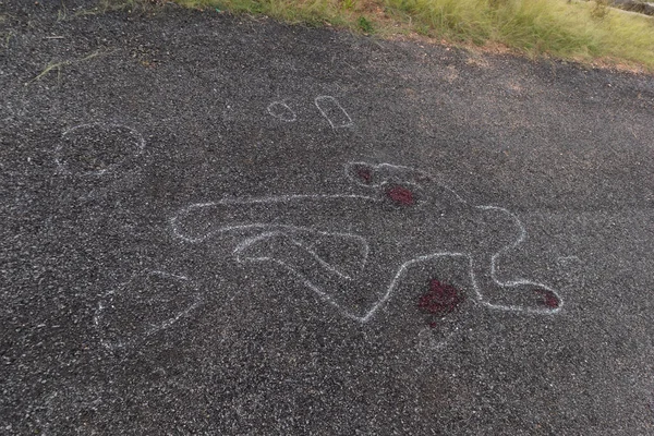 Crime scene chalk outline of victim dead body on Road with blood, Concept of murder investigation.