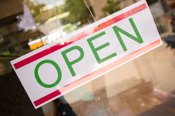 Open Signage board in front of Businesses or store door after covid-19 or coronavirus outbreak - Concept of back to business after lockdown.