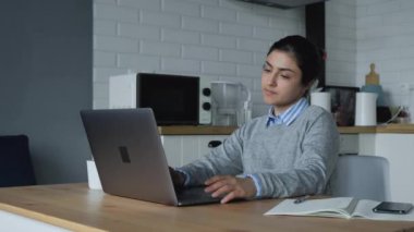 Bilgisayarda çalışan, dokunmatik ped kullanan, şirket mesajları yazan, müşterilerle iletişim kuran yorgun Hintli genç bir kadın. Millennial Hindu kız öğrenci dizüstü bilgisayarla ödev yapıyor.