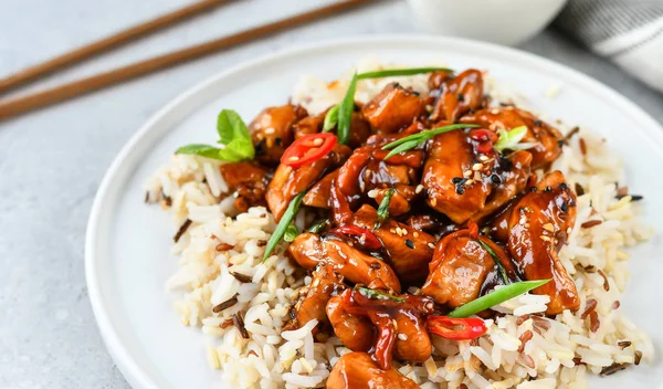 recipe teriyaki chicken\'s  with chili pepper and sesame seeds, with rice. on a white plate, copy space, selective focus, Asian cuisine, Chinese cuisine, Thai cuisine. food flat lay. light background
