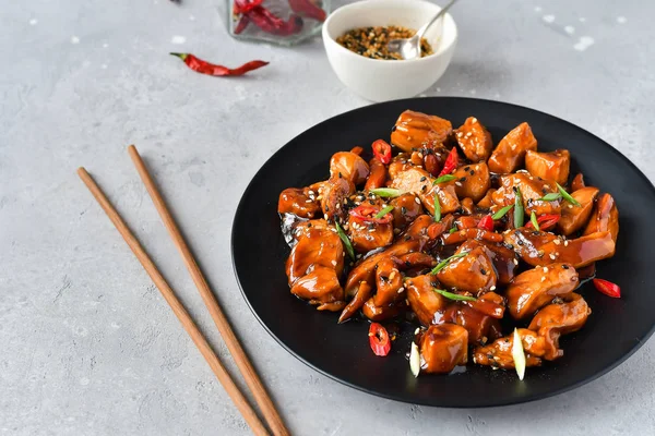 spicy chicken in sweet and sour sauce with chili pepper. teriyaki chicken\'s  with  sesame seeds. Chinese cuisine, Thai cuisine. Japanese food, copy space, recipe background, food flat lay