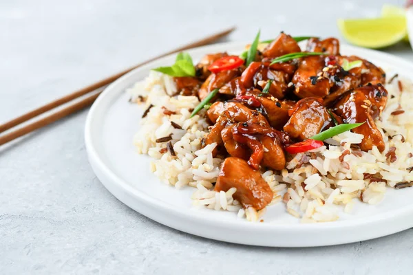 teriyaki chicken\'s  with chili pepper and sesame seeds, with rice. on a white plate, copy space, selective focus, Chinese cuisine,  food flat lay. light background, recipe background