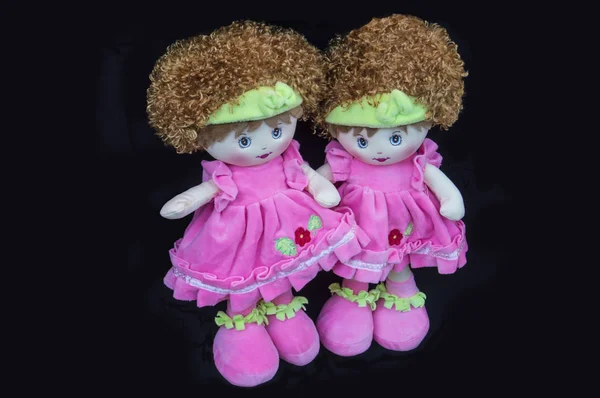 Two twin rag dolls isolated on black background