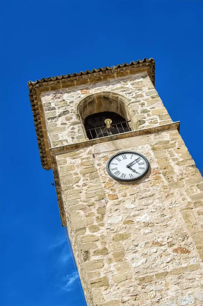 tower with clock and stone bell tower that forms part of the municipality of Mota del Cuervo, province of Cuenca. Castilla la Mancha. Spain.
