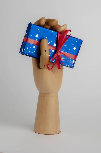 Articulated Wooden Hand Blue Gift Box — Stock Photo, Image