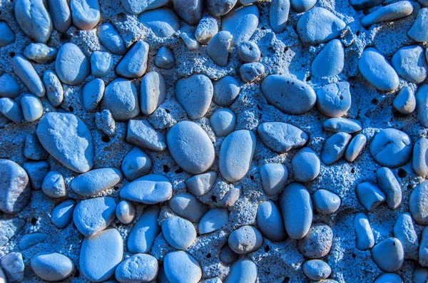 Background of blue painted stones on a facade