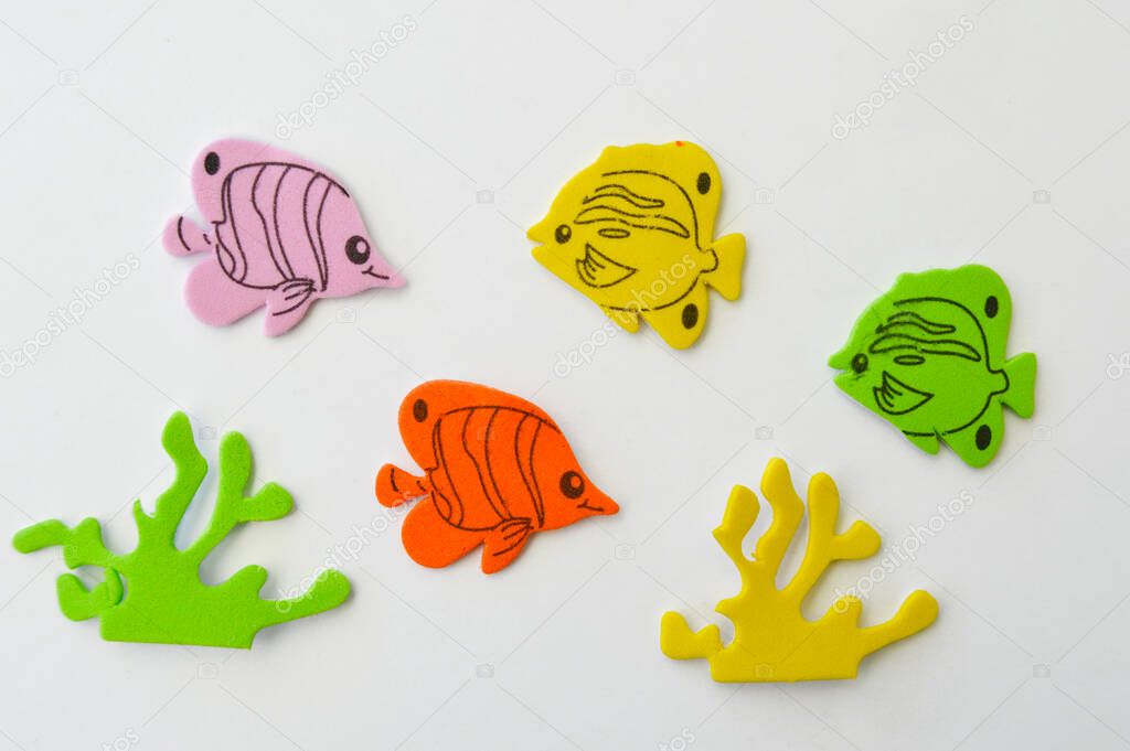 four eva rubber colors fish and two alfgae,  isolated on white background