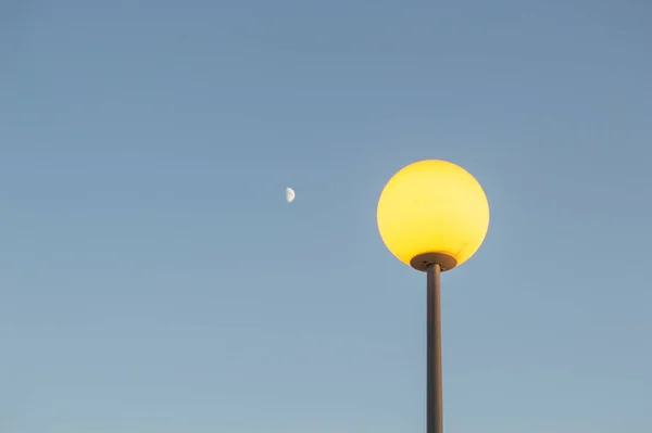 Bola Forma Poste Luz Cortado Contra Cielo Azul Luna Pequeña —  Fotos de Stock