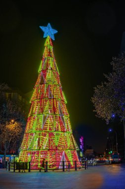 Christmas tree with colored lights on a street in Madrid, Spain