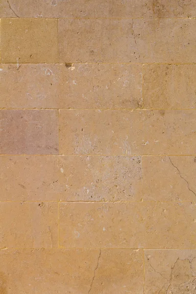Amarillo envejecido arenisca ladrillo pared fondo — Foto de Stock