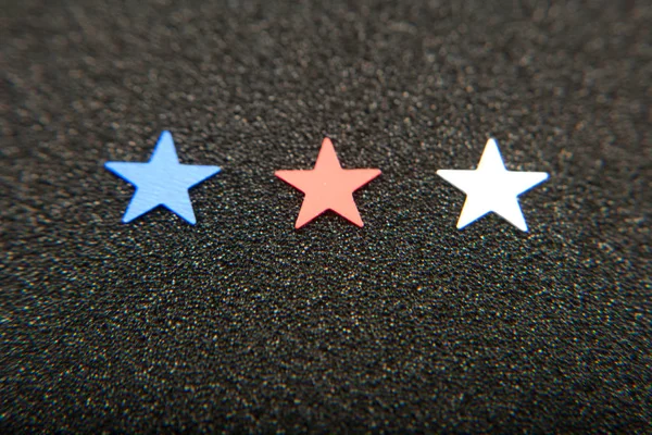 Confetti stars on wooden background. 4th July, Independence day, card, invitation in usa flag colors. View from Top , empty space.