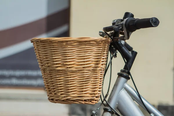 Bicycle with wicker basket on background