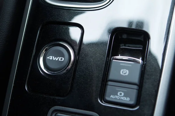 Electric drive button for parking brake and seat heating for a modern car. Round activation button 4WD. Interior of a close-up. — Stock Photo, Image