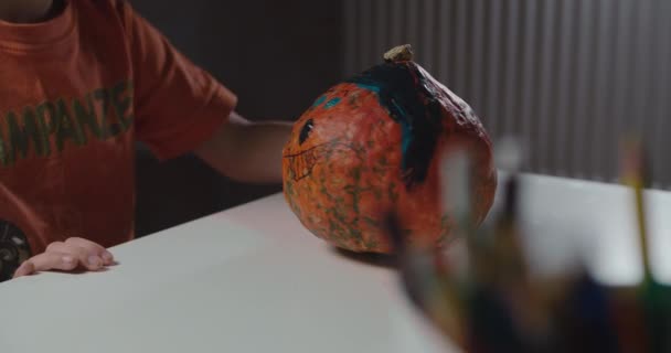 One boy decorating and painting pumpkin for halloween — Stock Video