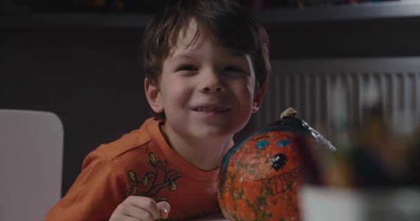 One boy decorating and painting pumpkin for halloween — Stock Video