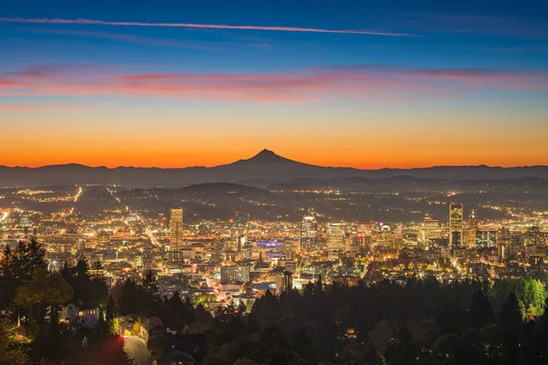 Portland downtown and Mt Hood at dawn; skyline; clouds; city lights
