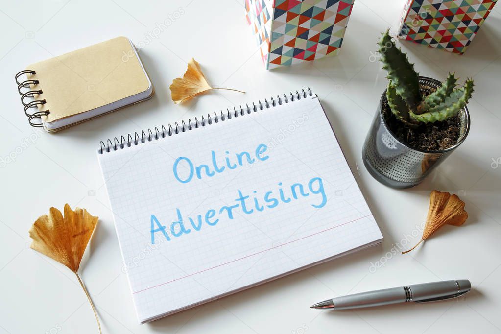 online advertising written in notebook on white table