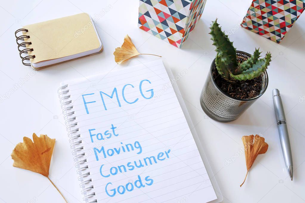 FMCG Fast Moving Consumer Goods written in notebook on white table