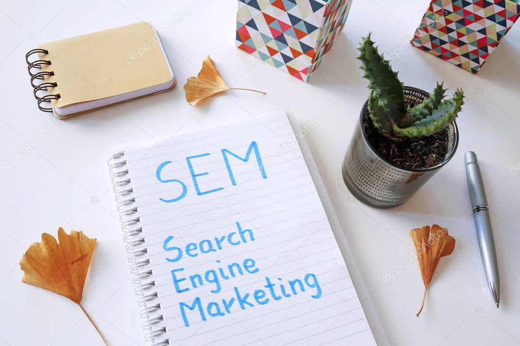 SEM Search Engine Marketing written in notebook on white table
