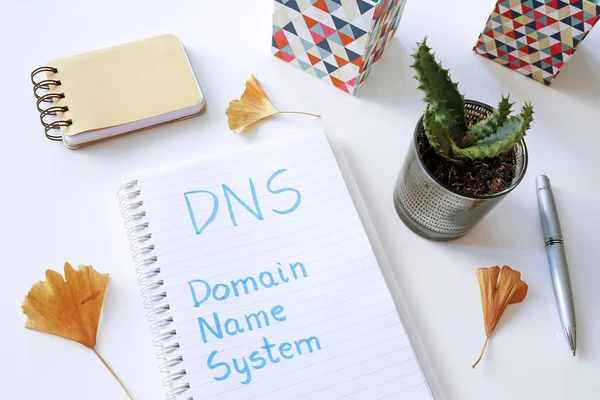 DNS Domain Name System written in notebook on white table