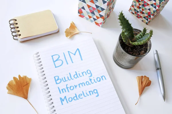 BIM Building Information Modeling written in notebook on white t