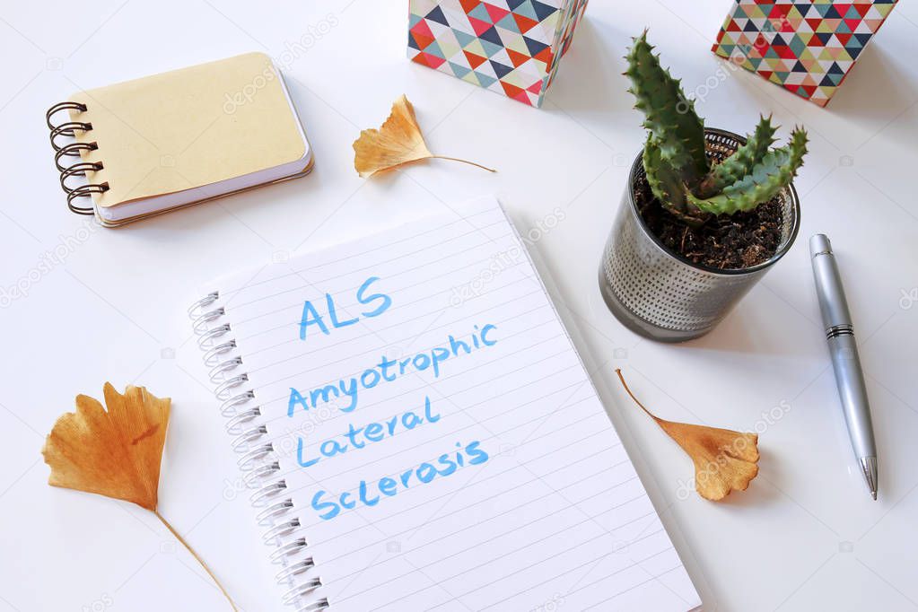ALS Amyotrophic Lateral Sclerosis written in notebook on white t