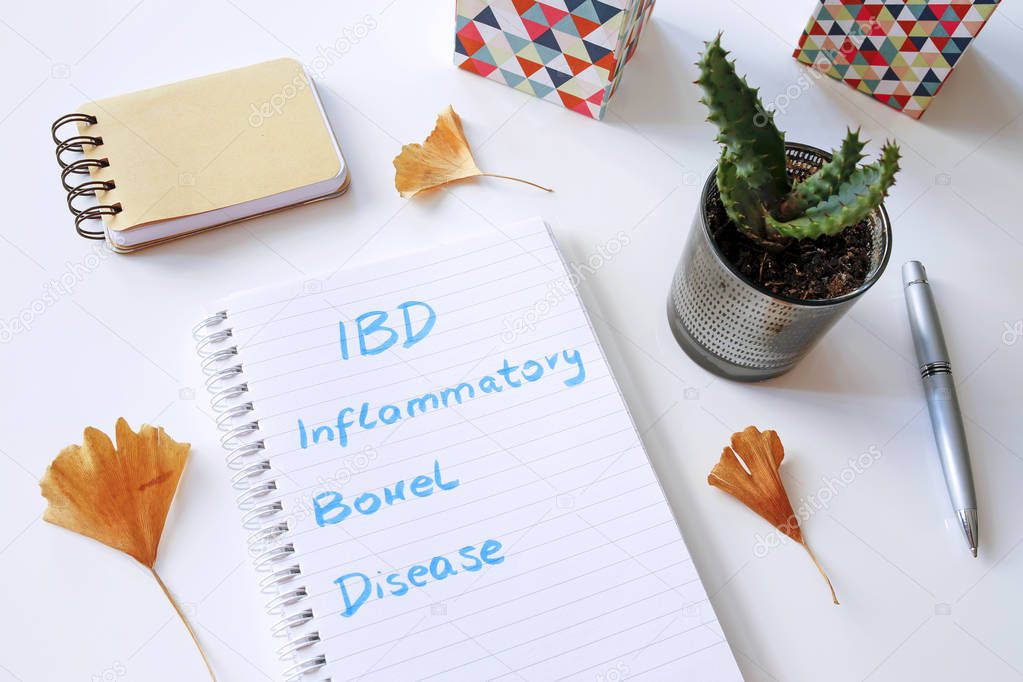 IBD Inflammatory Bowel Disease written in notebook on white tabl