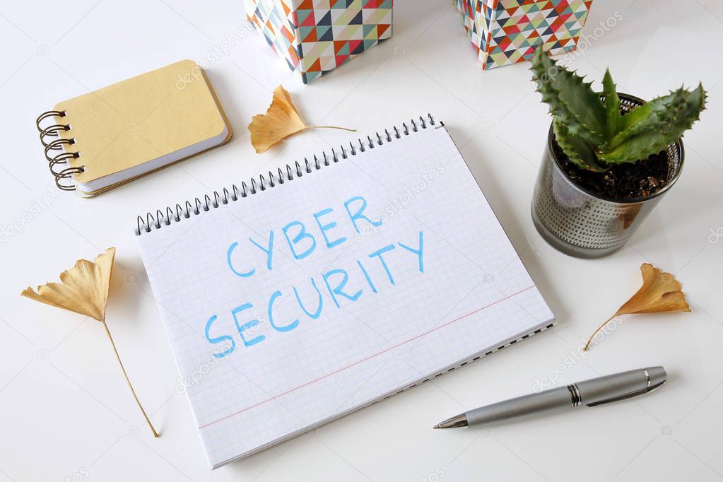 Cyber Security written in a notebook on white table