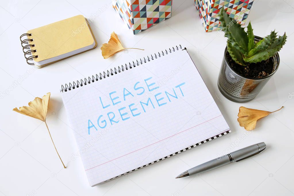 lease agreement written in a notebook on white table