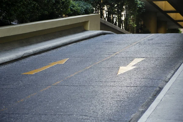 Yellow arrows on an entrance to garage parking — Stock Photo, Image