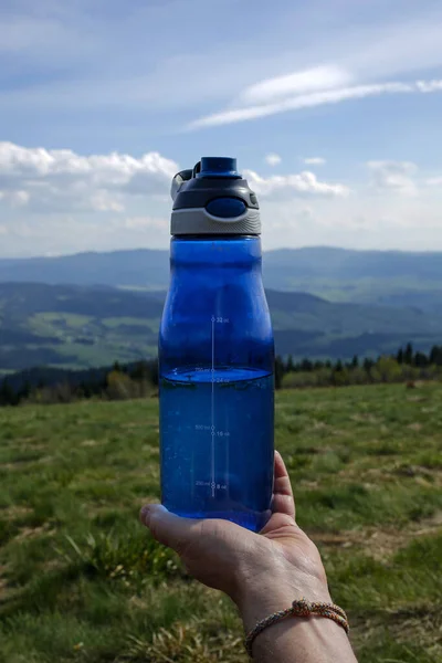 sport water bottle in the mountains