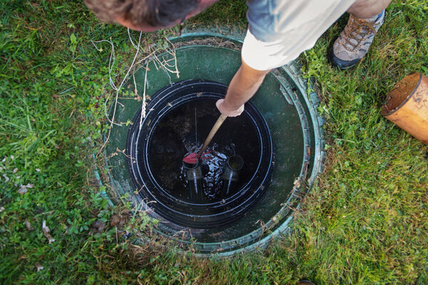 Cleaning and unblocking septic system. View from above.