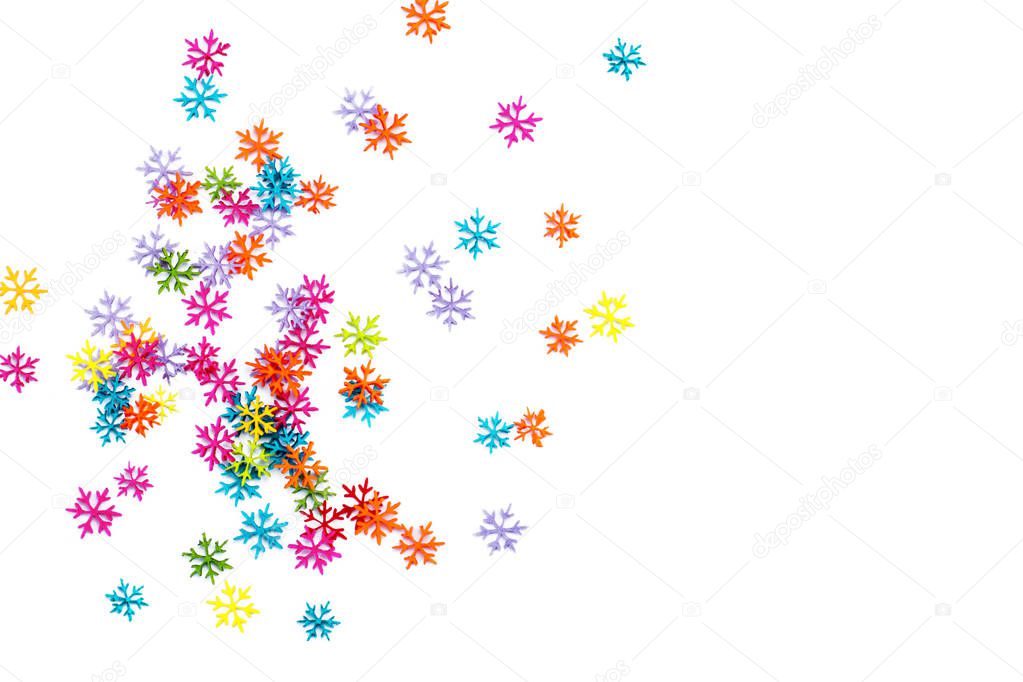 A scattering of multicolored snowflakes on white