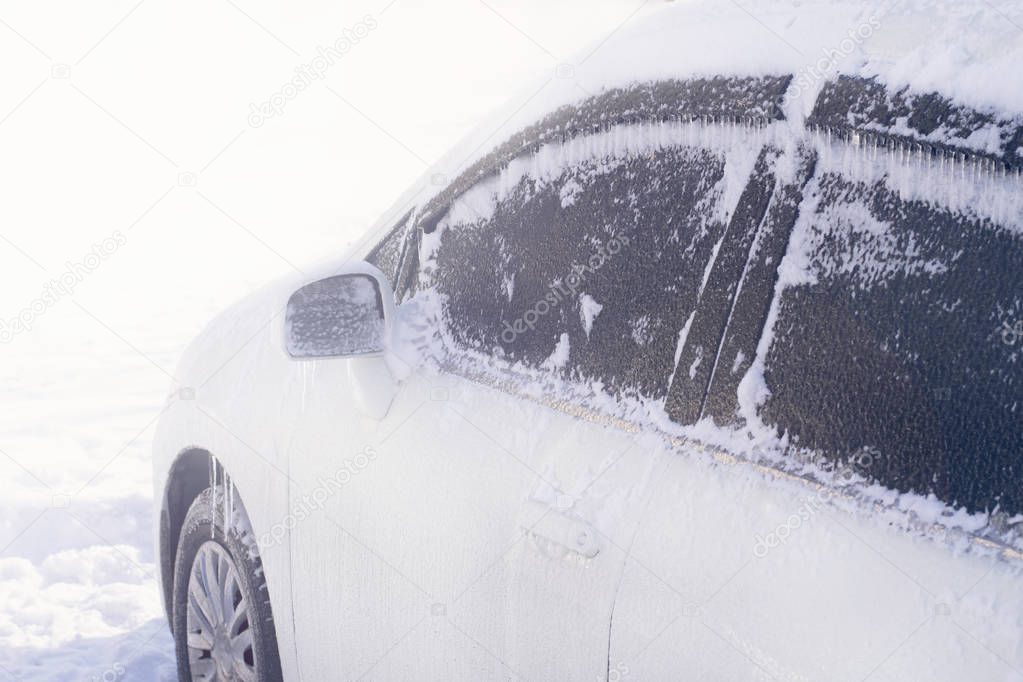  Frozen white car in a cold winter morning